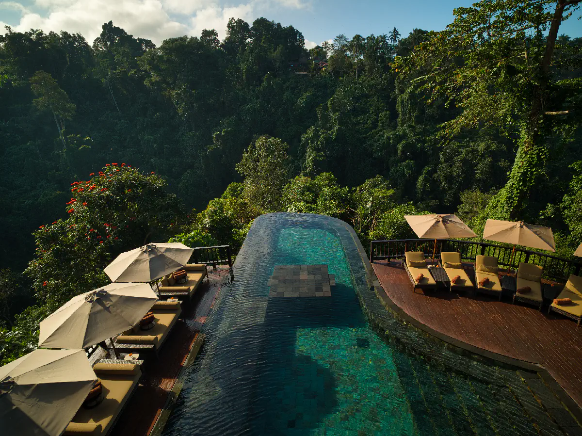 Luxury infinity pool at Hanging Gardens of Bali during warm March rainfall