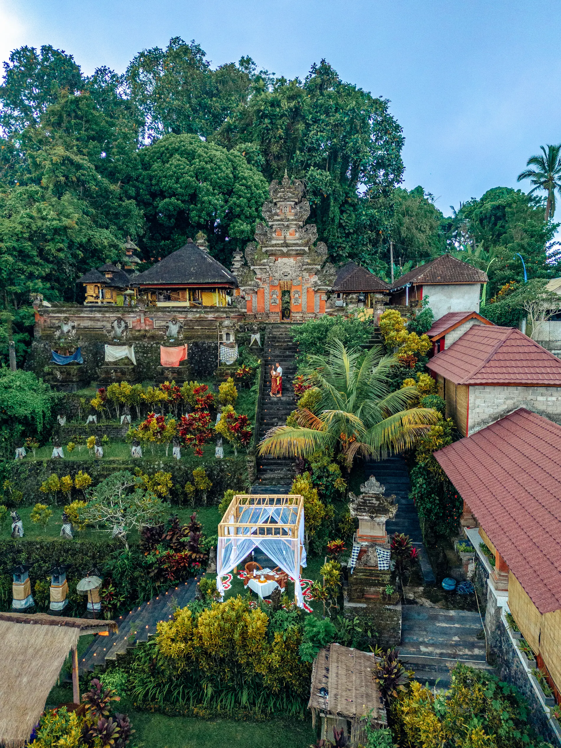 Private candlelit temple dinner in Bali at Hanging Gardens Ubud, exclusive luxury dining with jungle and mountain views.