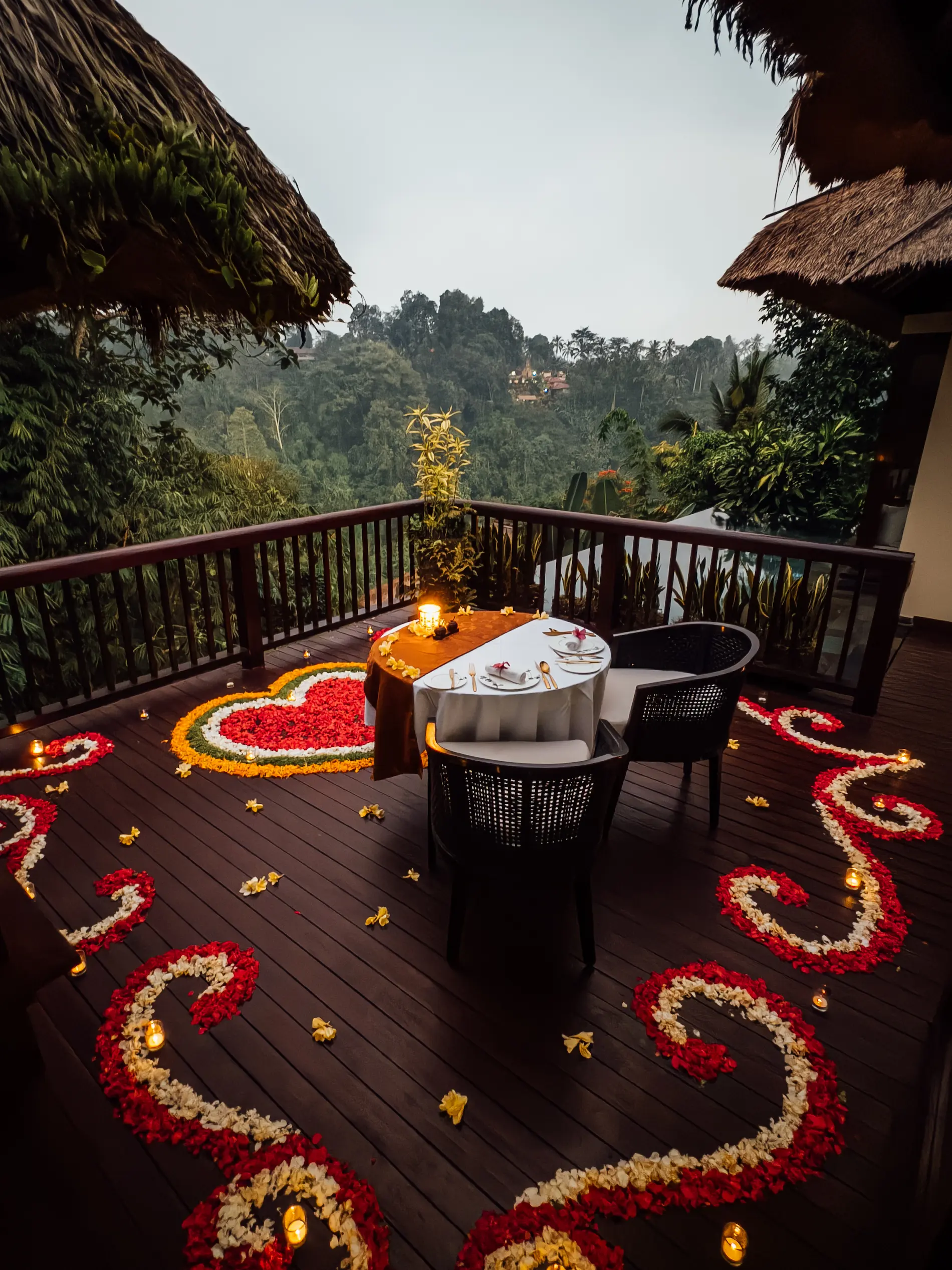 Romantic in-villa dining at Hanging Gardens of Bali with private table, candlelight, and jungle views in Ubud.
