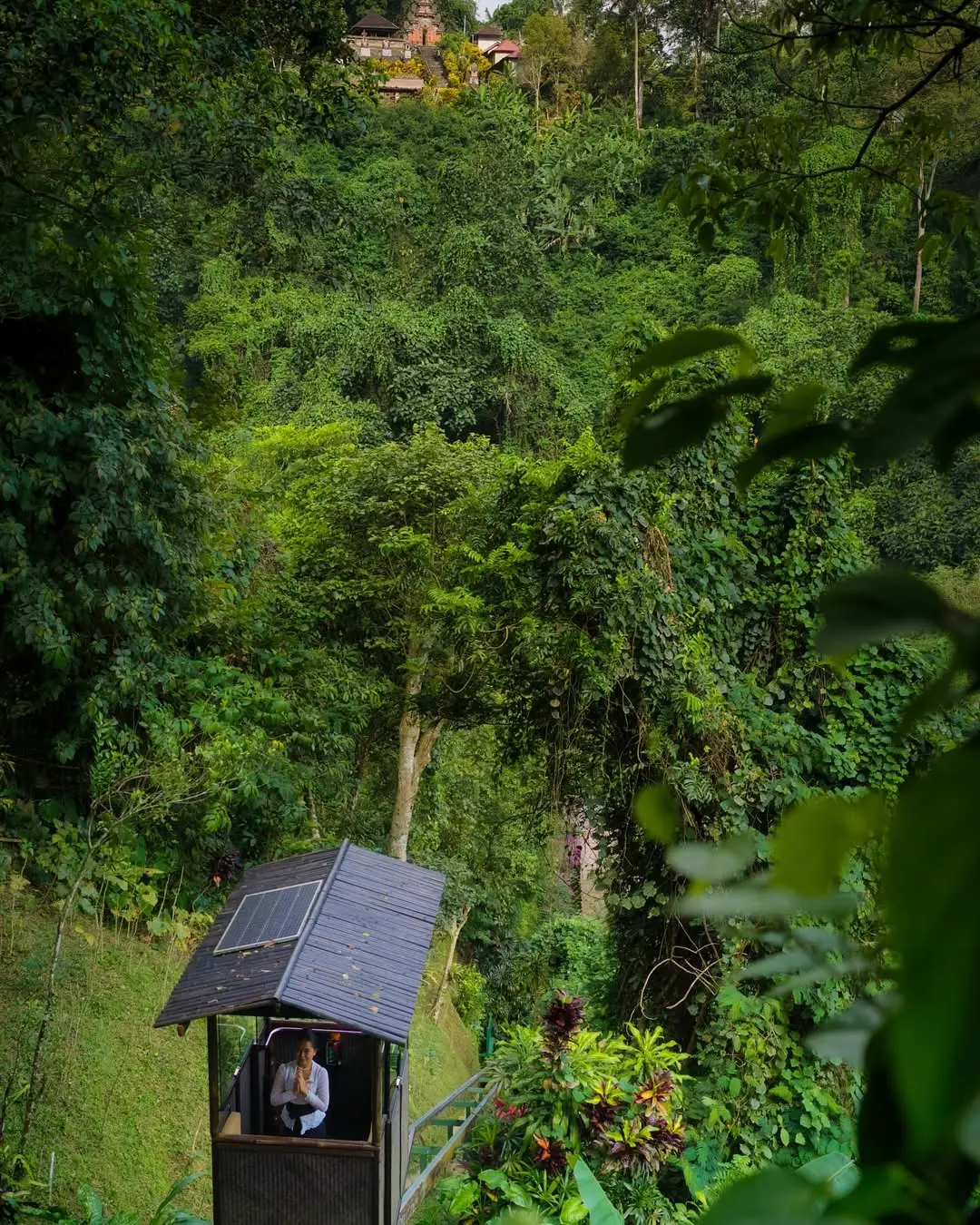 Secluded VIP entrance to The Hidden Palace villa estate at Hanging Gardens Bali surrounded by lush greenery