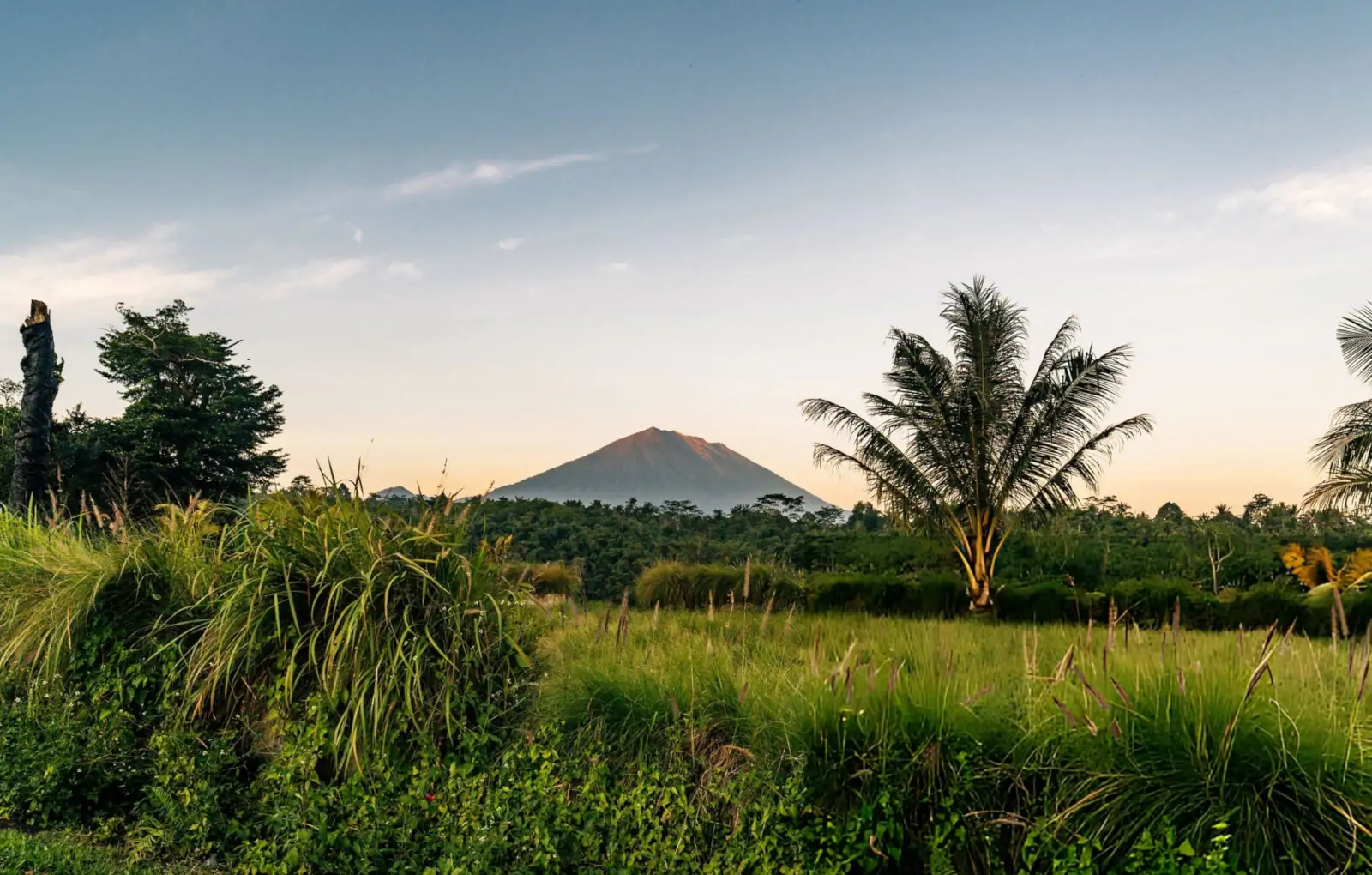 Bali shoulder season landscape with warm light, tropical greenery, and calm weather