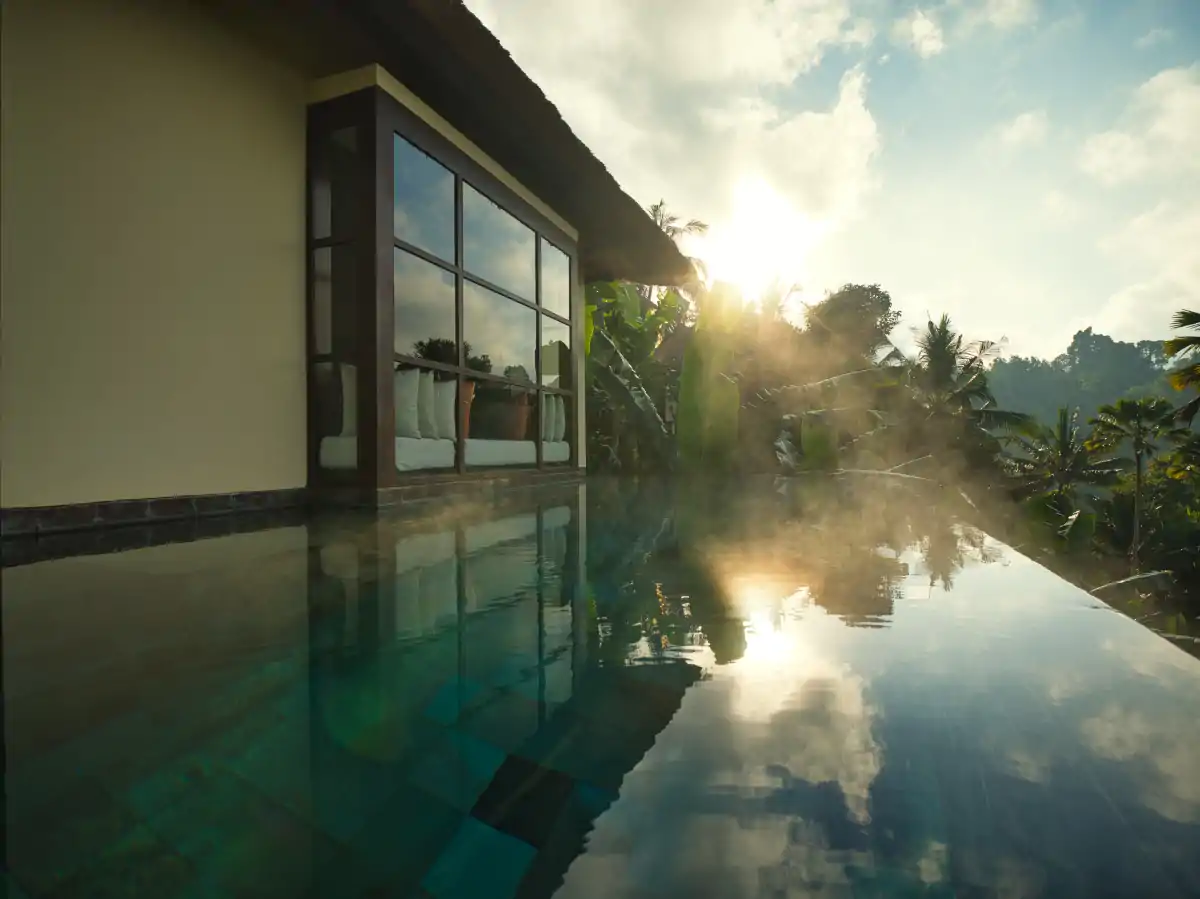 Private villa infinity pool at Hanging Gardens of Bali surrounded by rainforest during Bali summer