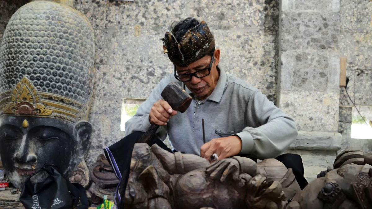 Balinese artisan working in a traditional studio near Ubud