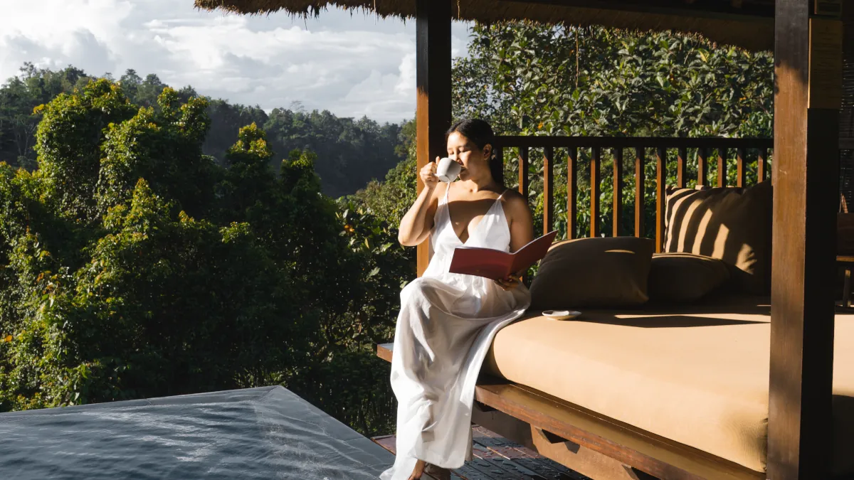 Guest relaxing beside a luxury infinity pool in the Ubud rainforest